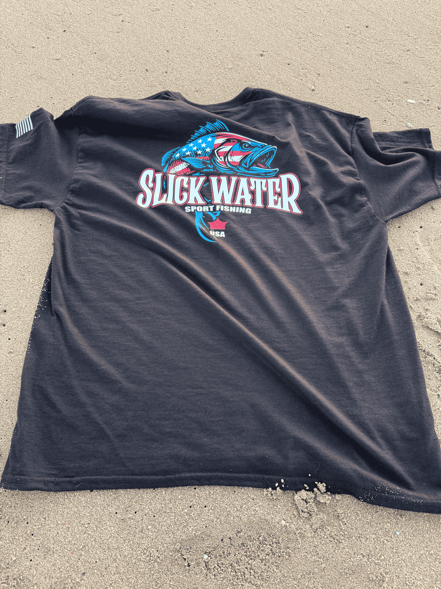 Black sleeveless shirt with a logo on a concrete surface